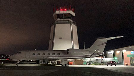 Airplane and tower at night at Van Nuys airport